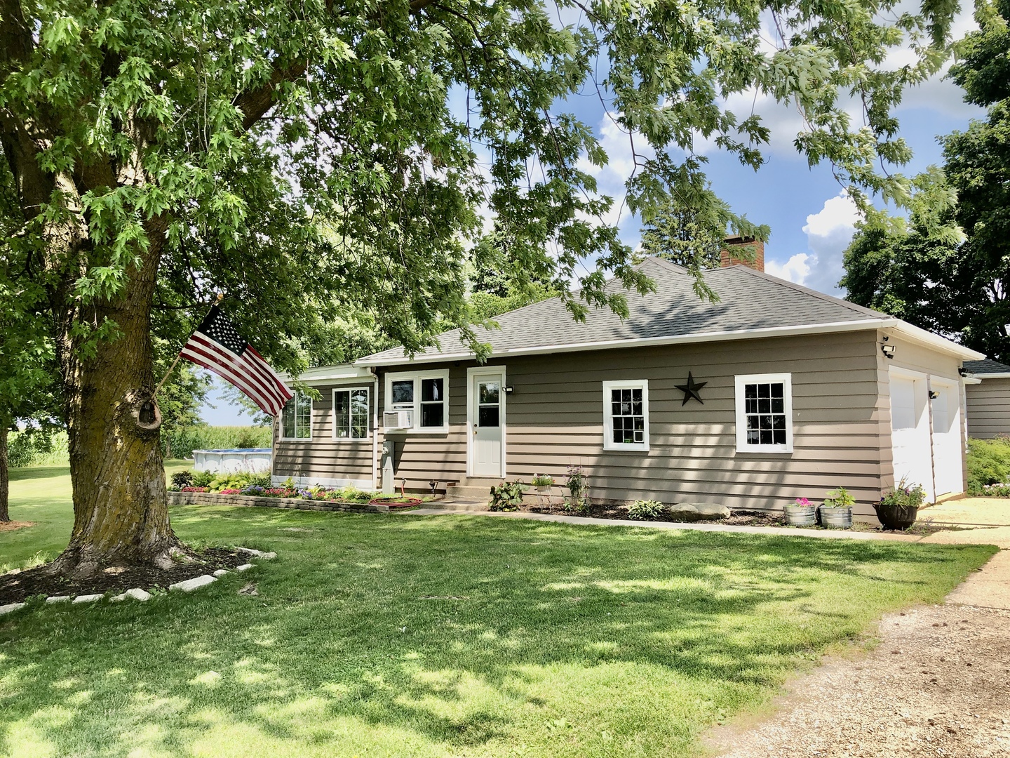 12907 Barber Greene Road Sycamore, IL 60178 - Photo 4 of 42 a front view of house with yard and trees in the background