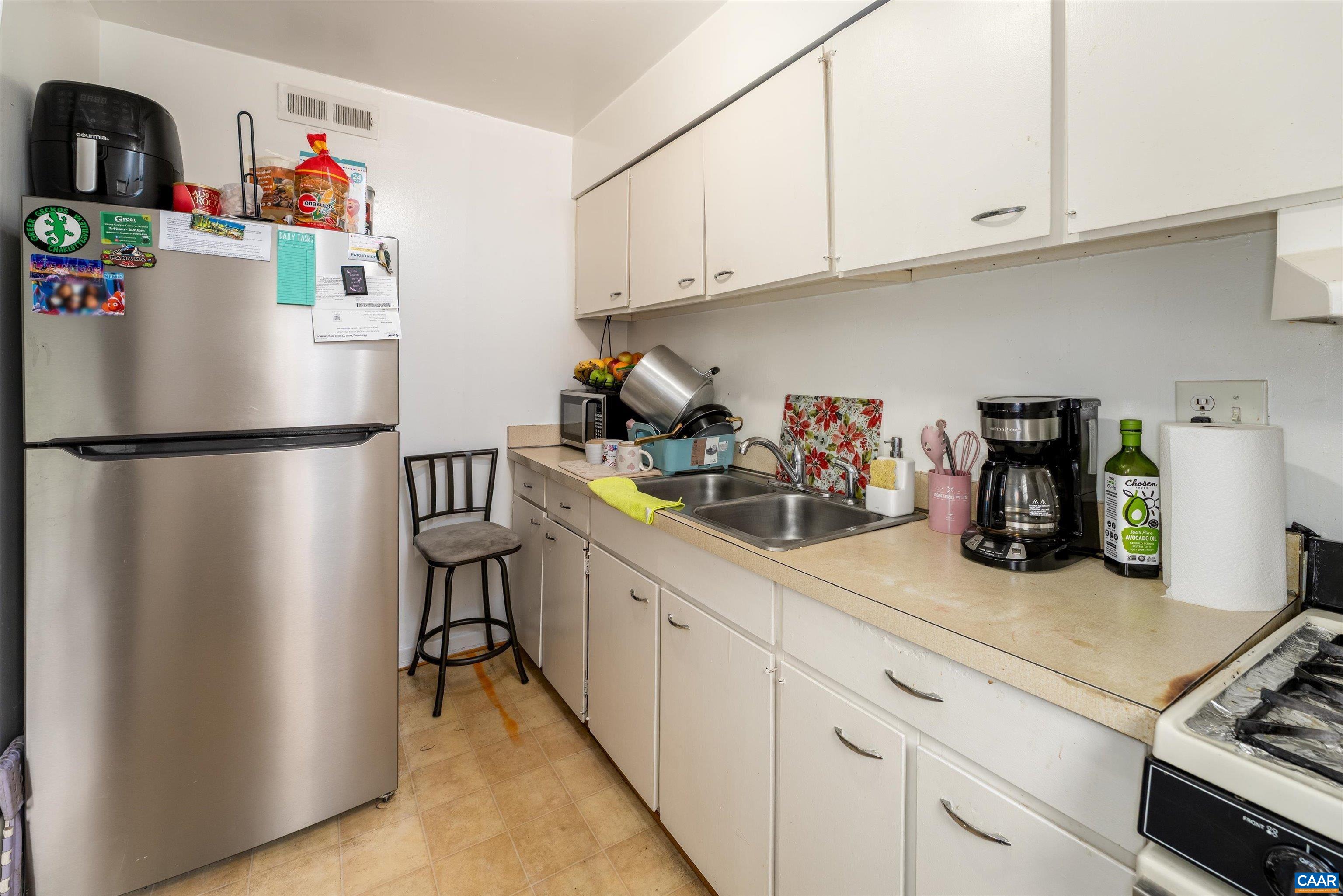 2517 Hydraulic Road, Unit 73 Charlottesville, VA 22901 - Photo 12 of 22 a kitchen with refrigerator and cabinets