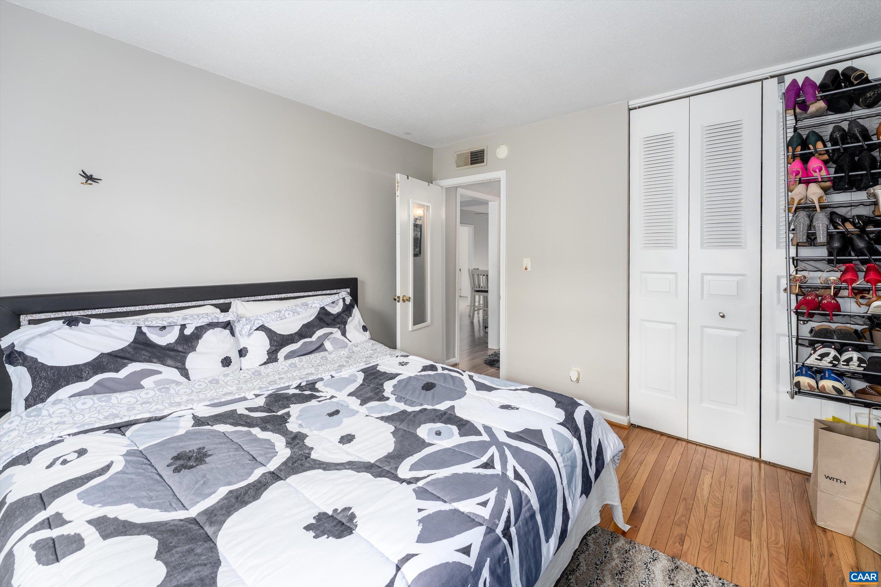 2517 Hydraulic Road, Unit 73 Charlottesville, VA 22901 - Photo 16 of 22 a bedroom with a large bed and a book shelf