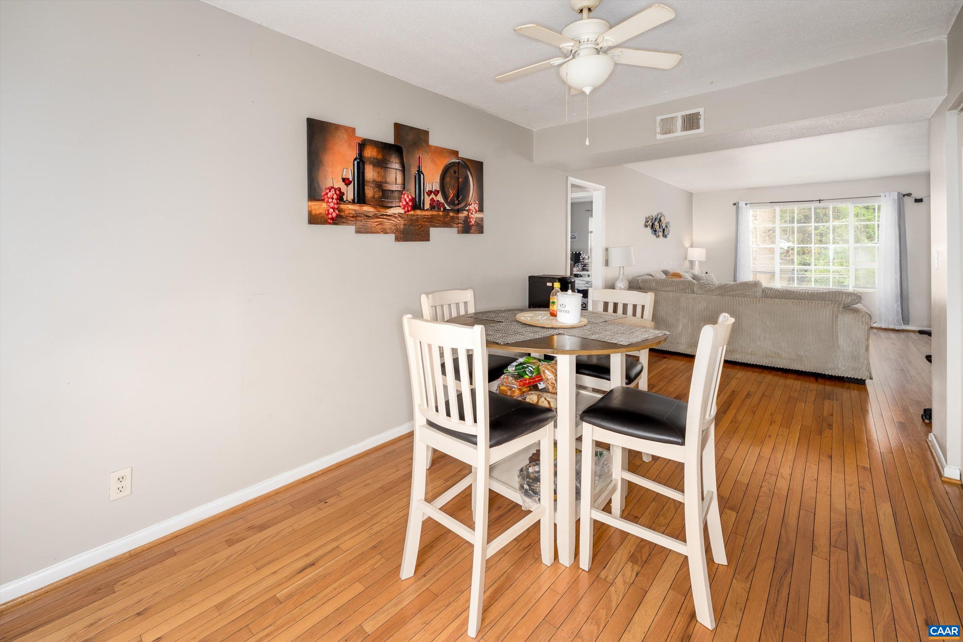 2517 Hydraulic Road, Unit 73 Charlottesville, VA 22901 - Photo 10 of 22 a view of a dining room with furniture and wooden floor