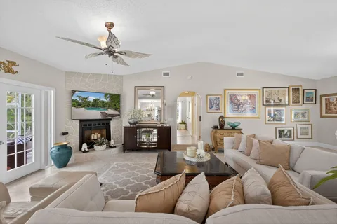 a view of a dining room with furniture a chandelier and window