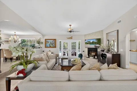 a kitchen with kitchen island a dining table chairs sink and cabinets