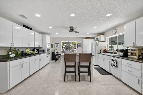 a bathroom with a shower sink vanity and mirror