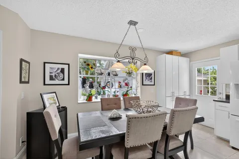 a living room with a bed furniture and a potted plant