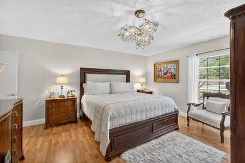 a view of a dining room with furniture and a floor to ceiling window