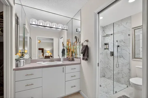 a living room with patio furniture and a large window