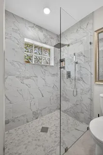 a living room with patio furniture and a large window