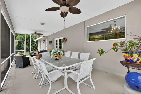 an aerial view of residential house with outdoor space and trees all around