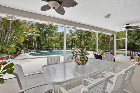 an aerial view of a house with a yard basket ball court and outdoor seating