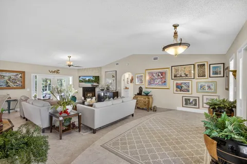 a living room with furniture a fireplace and a window