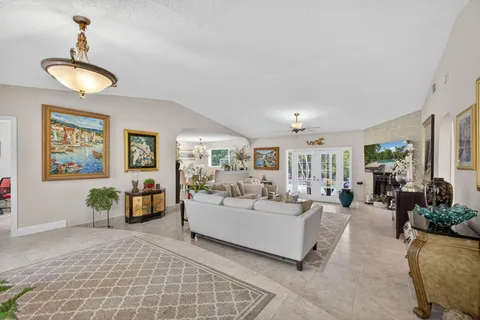 a living room with furniture fireplace and a large window