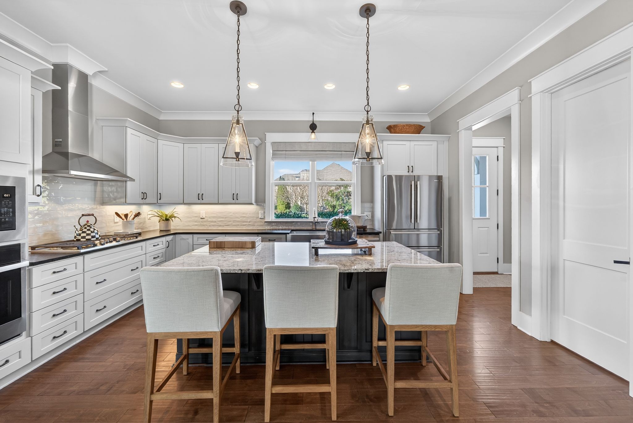 998 Spruce Ridge Lane Spring Hill, TN 37174 - Photo 24 of 82 a kitchen with stainless steel appliances a dining table chairs and white cabinets