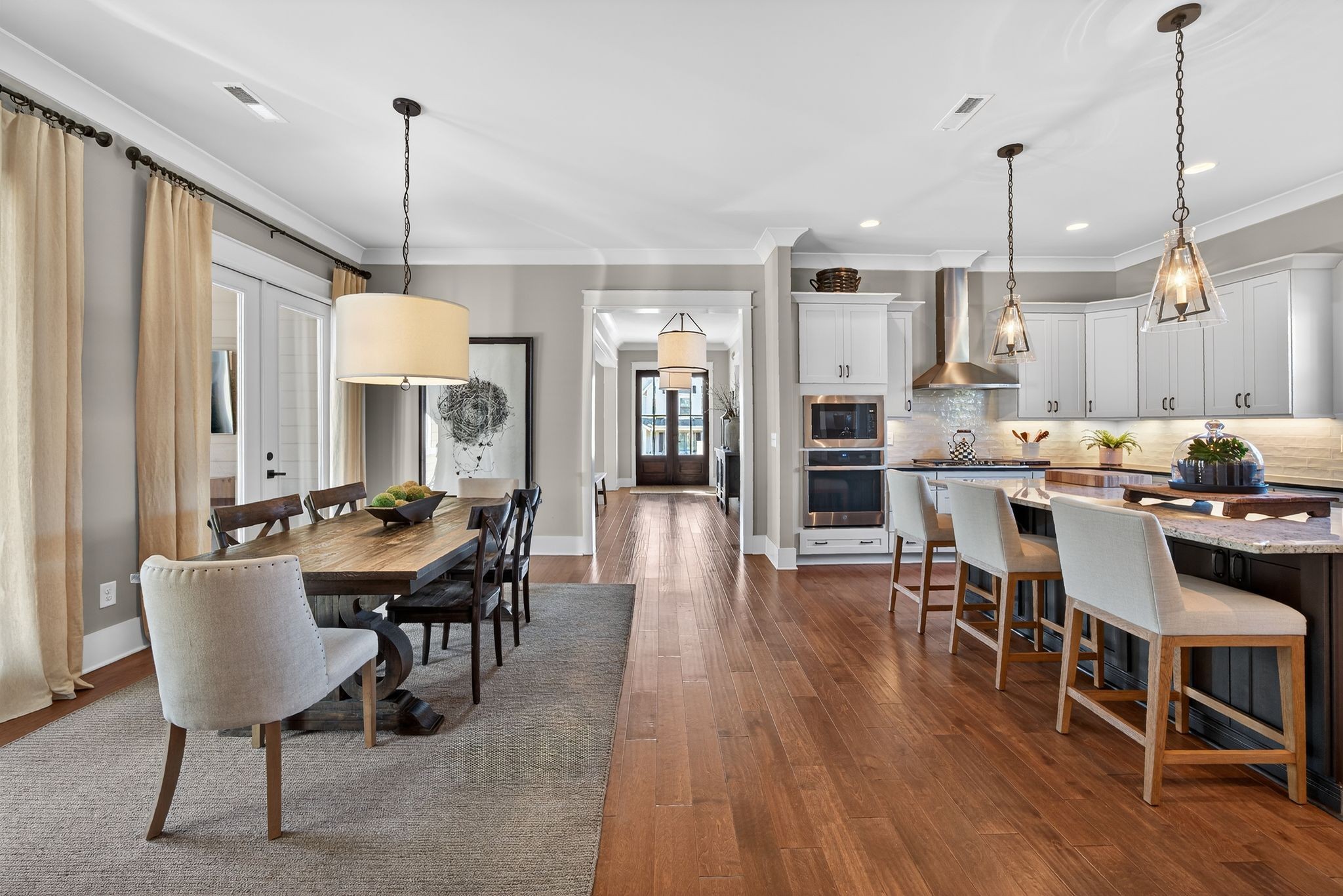 998 Spruce Ridge Lane Spring Hill, TN 37174 - Photo 35 of 82 a view of a dining room and livingroom with furniture wooden floor a chandelier