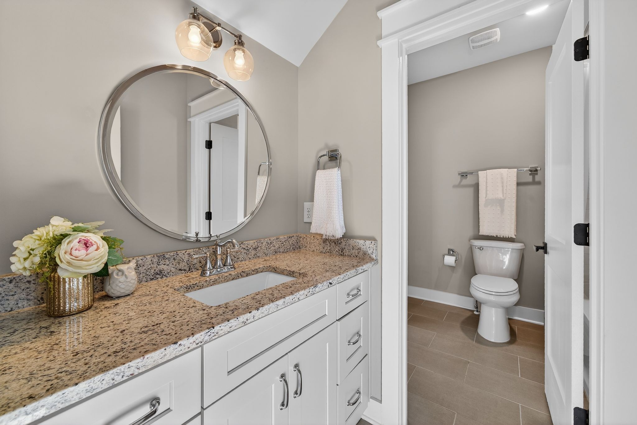 998 Spruce Ridge Lane Spring Hill, TN 37174 - Photo 56 of 82 a bathroom with a granite countertop sink a toilet and a mirror
