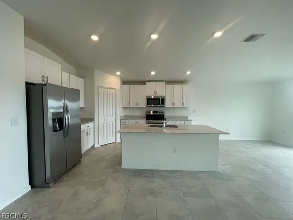 a kitchen with stainless steel appliances a refrigerator sink and stove