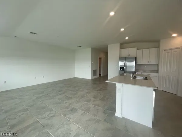 a kitchen with stainless steel appliances a sink stove and refrigerator