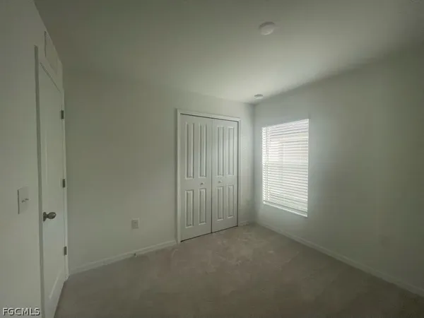 a view of an empty room and a window