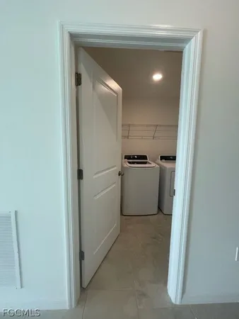 a view of a refrigerator in kitchen and a cabinets