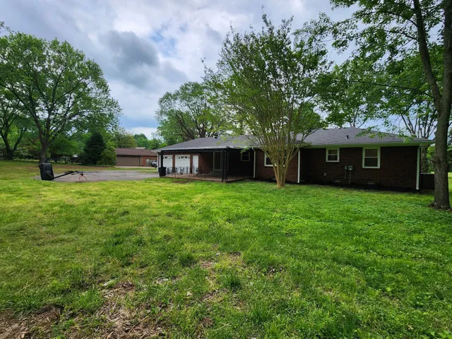 a house view with a sitting space and garden
