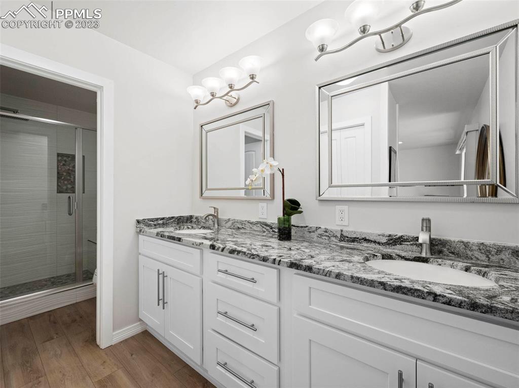 2622 Spring Grove Terrace Colorado Springs, CO 80906 - Photo 14 of 37 a bathroom with double vanity sinks and a mirror