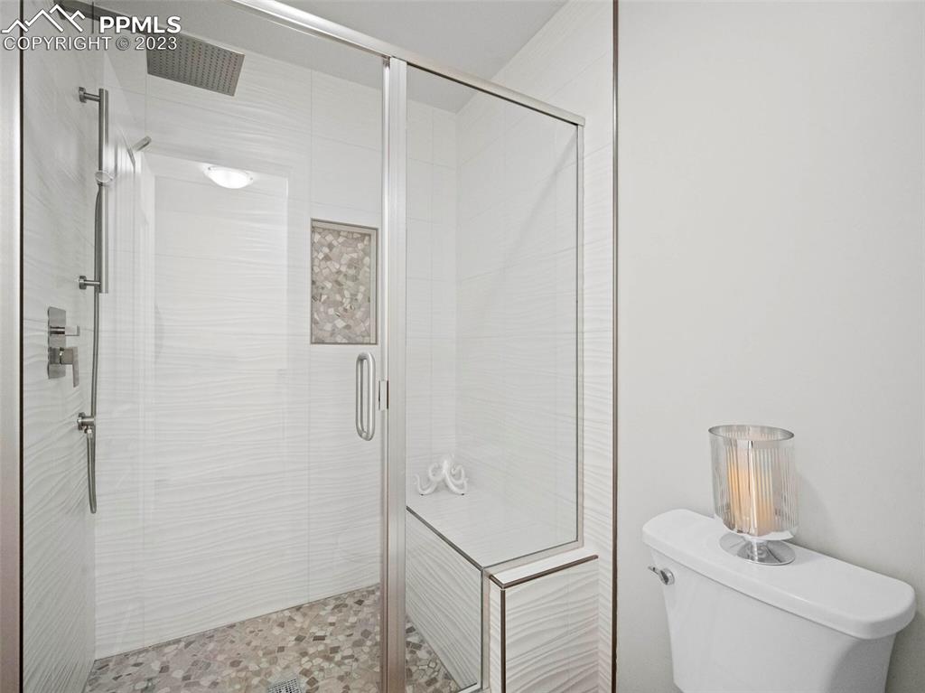 2622 Spring Grove Terrace Colorado Springs, CO 80906 - Photo 15 of 37 a bathroom with a shower a toilet and sink