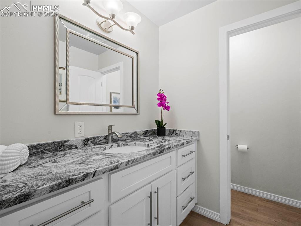 2622 Spring Grove Terrace Colorado Springs, CO 80906 - Photo 23 of 37 a bathroom with a granite countertop sink vanity and mirror