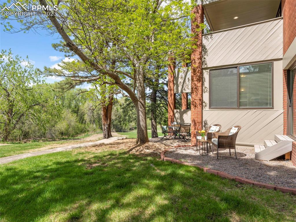 2622 Spring Grove Terrace Colorado Springs, CO 80906 - Photo 26 of 37 a view of a backyard with table and chairs and a fire pit
