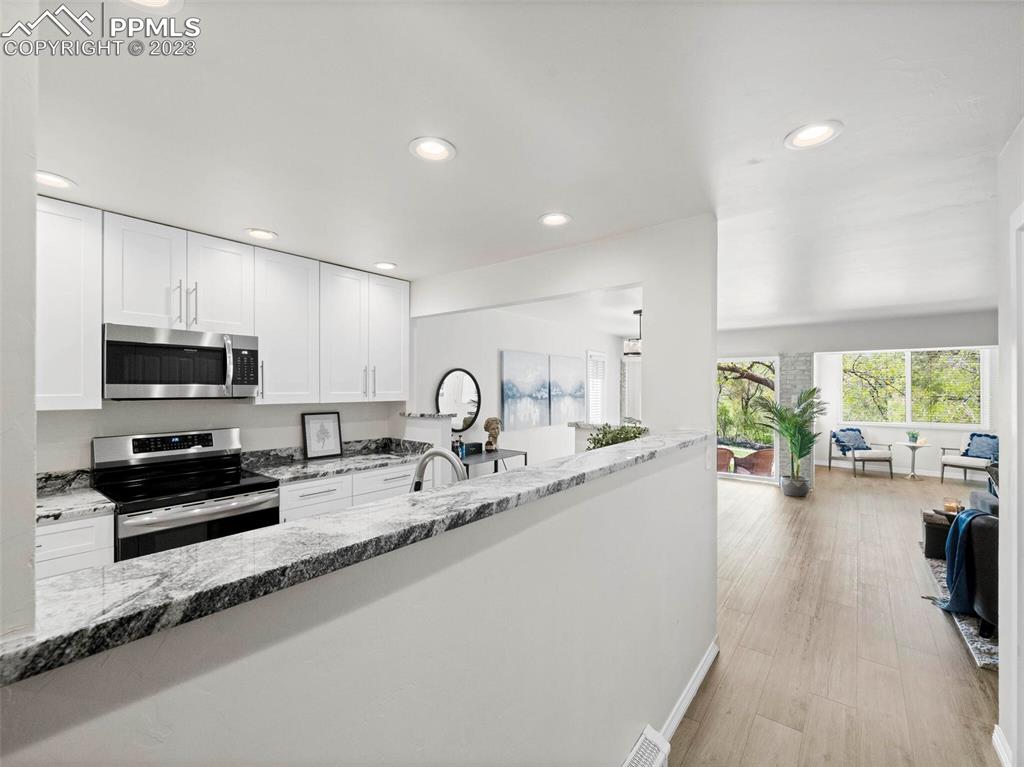 2622 Spring Grove Terrace Colorado Springs, CO 80906 - Photo 27 of 37 a kitchen with sink a stove and cabinets