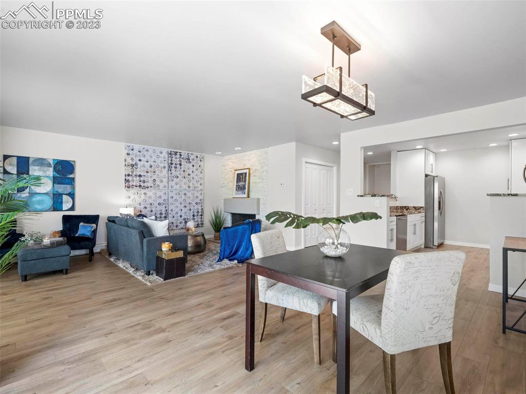 2622 Spring Grove Terrace Colorado Springs, CO 80906 - Photo 29 of 37 a view of a dining room with furniture window and wooden floor