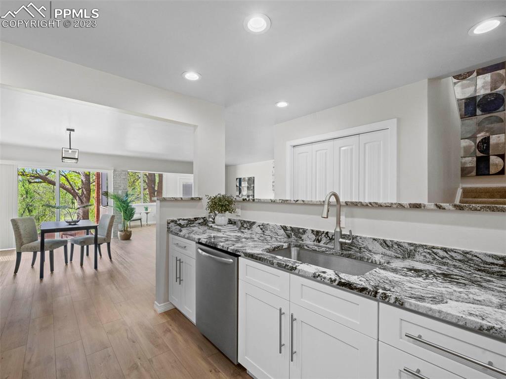 2622 Spring Grove Terrace Colorado Springs, CO 80906 - Photo 5 of 37 a kitchen with a table chairs stove and wooden floor