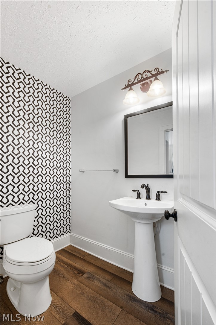 371 Merriman Road Akron, OH 44303 - Photo 12 of 27 Pedestal sink with black hardware, framed mirror, and decorative wall sconce lighting