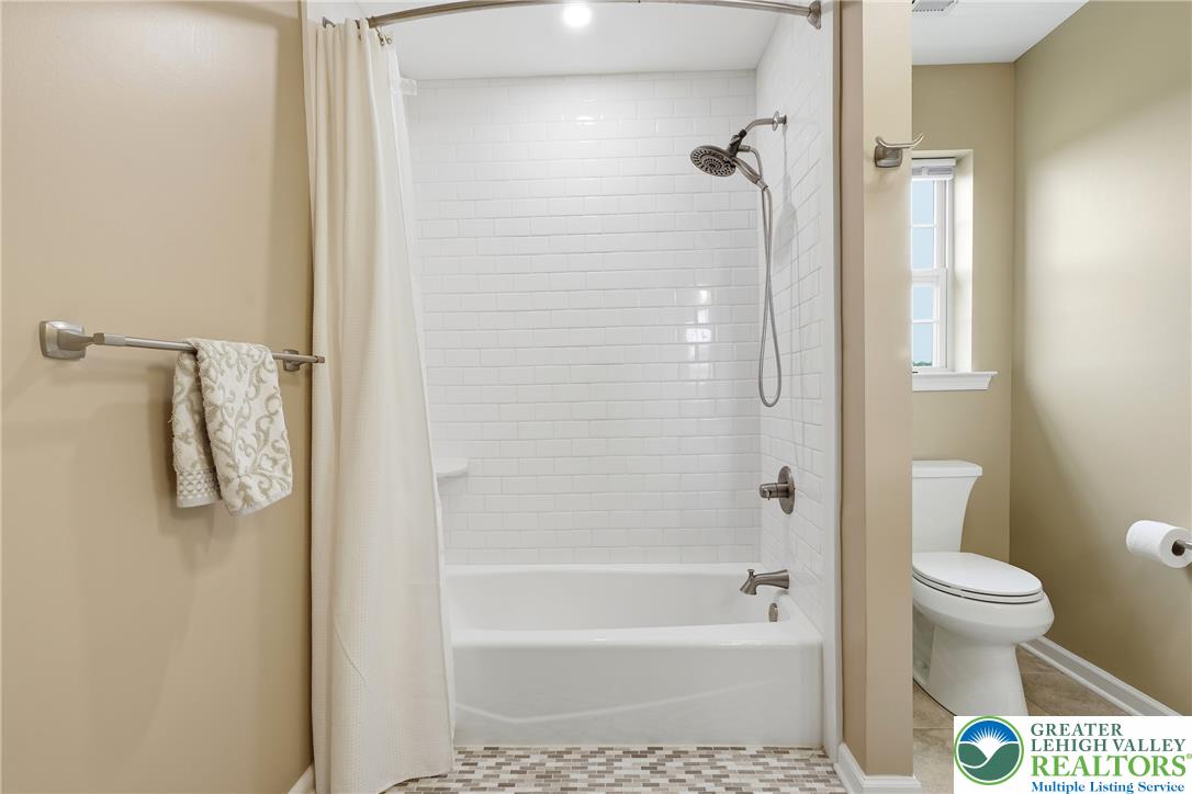 245 East Dell Road Bath, PA 18014 - Photo 49 of 99 A pristine tub and shower combination with subway tile surround offers a clean, functional bathing space.