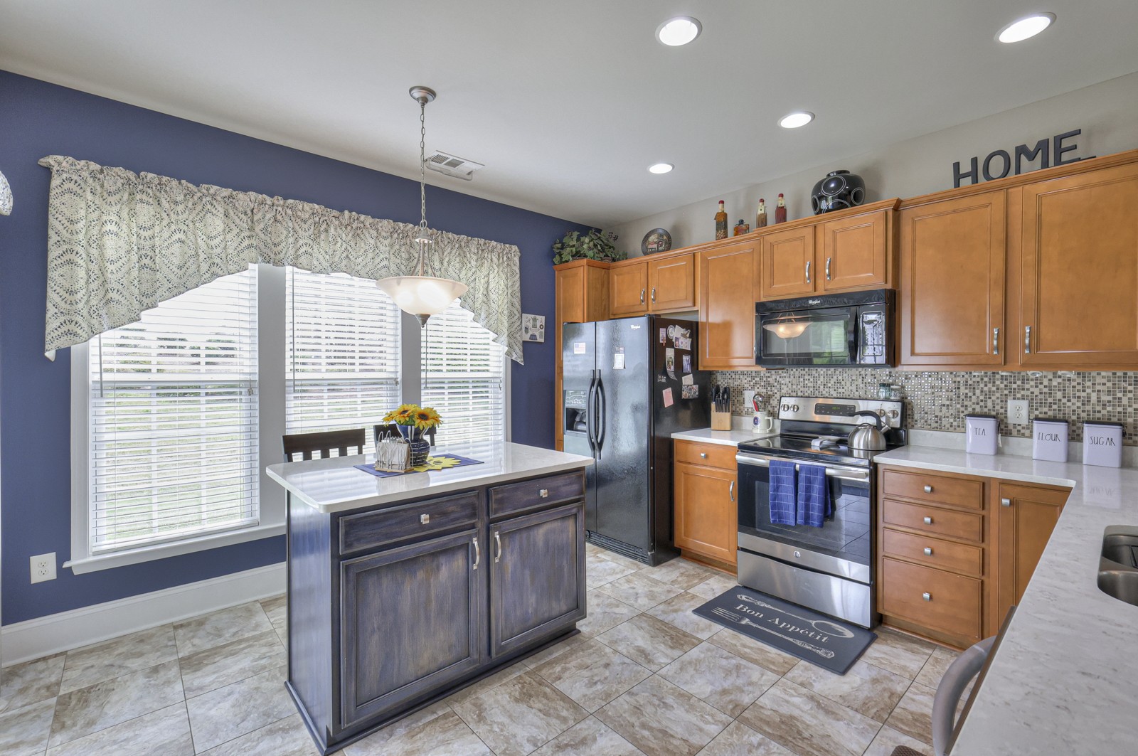 411 Independence Street Mount Juliet, TN 37122 - Photo 15 of 39 a kitchen with stainless steel appliances kitchen island granite countertop a sink stove and refrigerator
