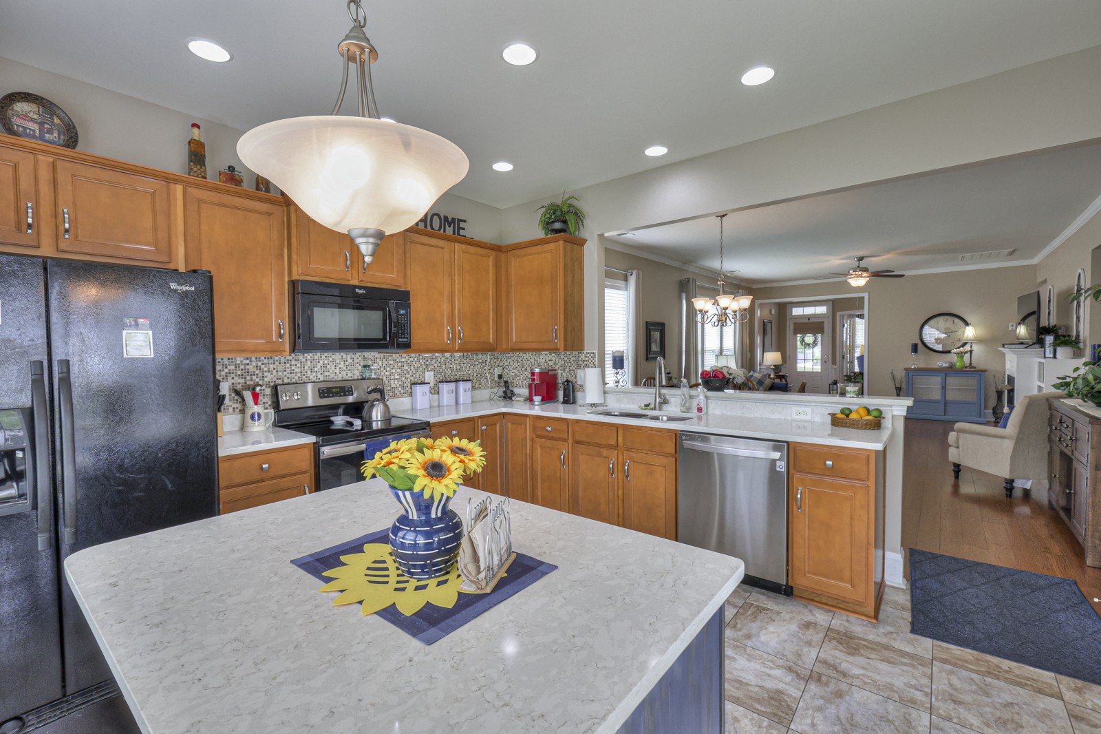 411 Independence Street Mount Juliet, TN 37122 - Photo 16 of 39 a kitchen with stainless steel appliances granite countertop a refrigerator a stove top oven a sink dishwasher and white cabinets with wooden floor