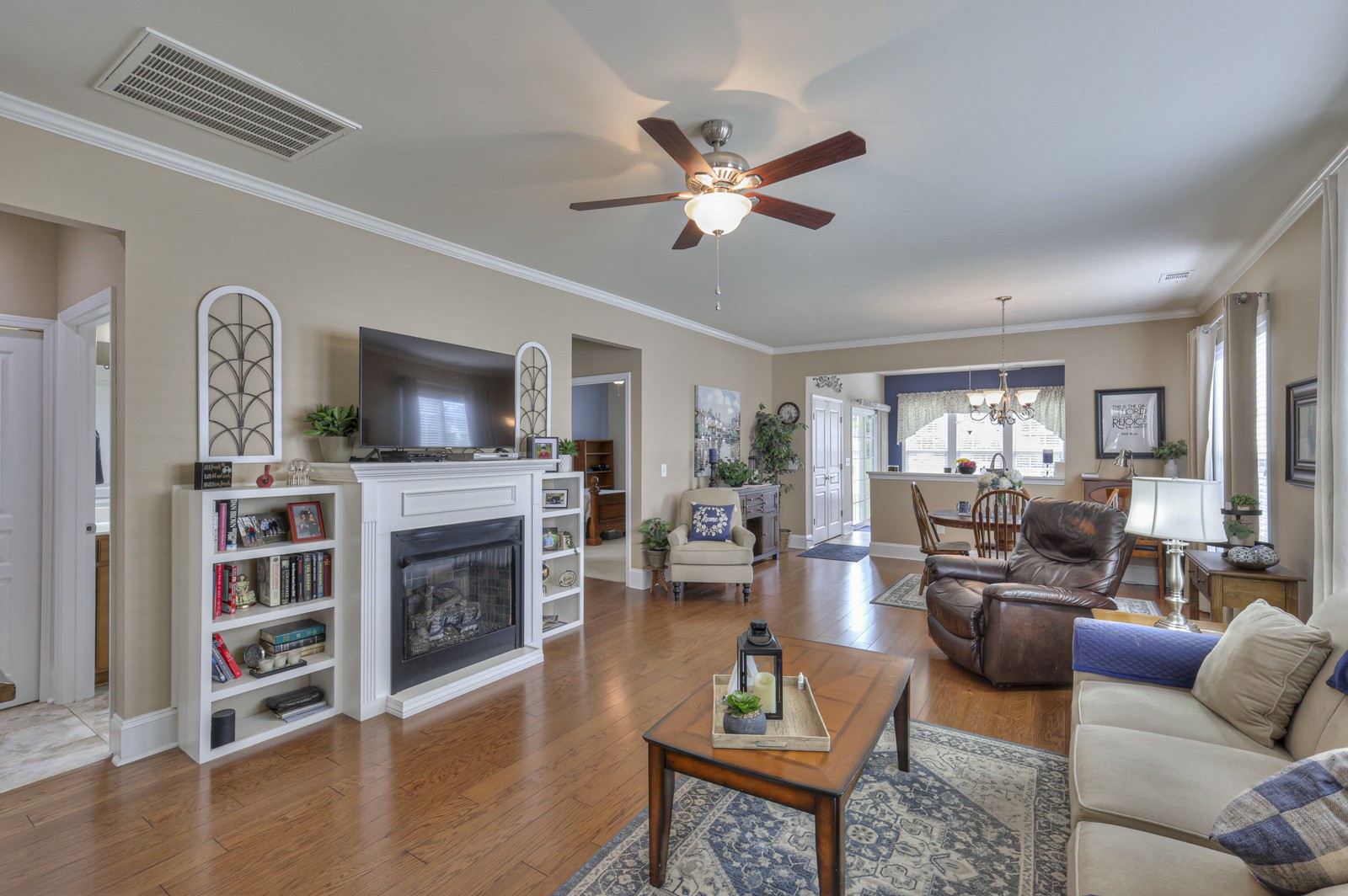 411 Independence Street Mount Juliet, TN 37122 - Photo 7 of 39 a living room with furniture a flat screen tv and a fireplace