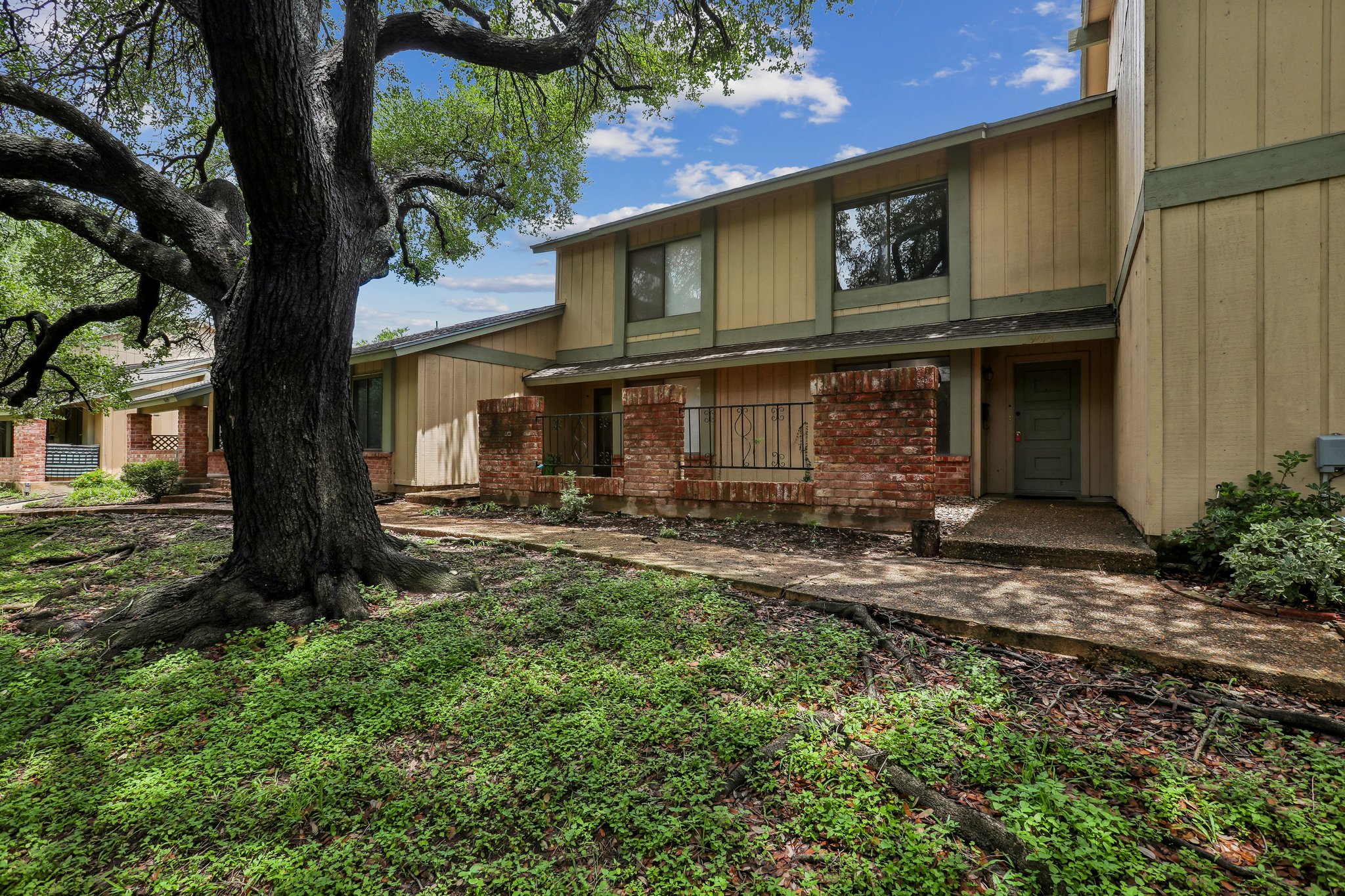 9613 Covey Ridge Lane Austin, TX 78758 - Photo 1 of 1 Mature trees frame the welcoming facade of this two-story residence, offering a serene entry.