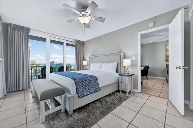 a bedroom with a bed and a large window