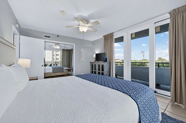 a large bedroom with a bed and a chandelier