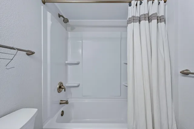 a bathroom with a bathtub and shower