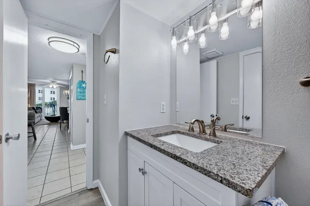 a bathroom with a sink vanity and a mirror