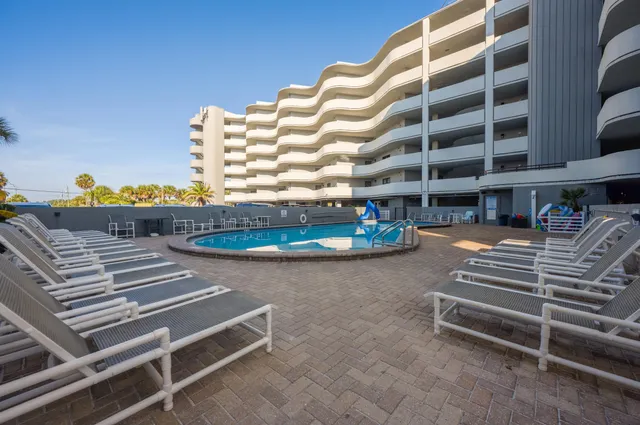 a view of a patio with a table and chairs