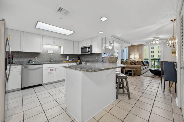 a kitchen with cabinets and chairs