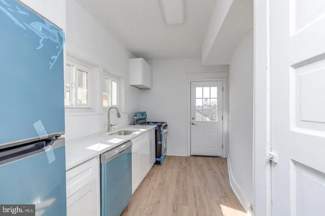 a kitchen with a sink cabinets and a window