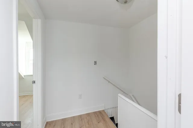 an empty room with wooden floor and closet