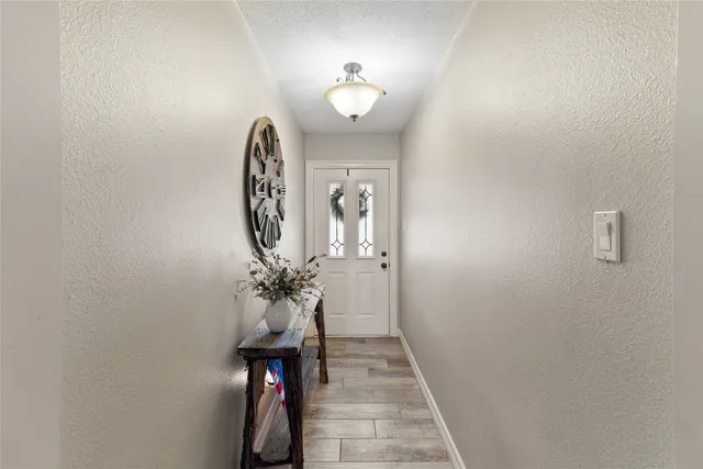 a view of a hallway with chandelier