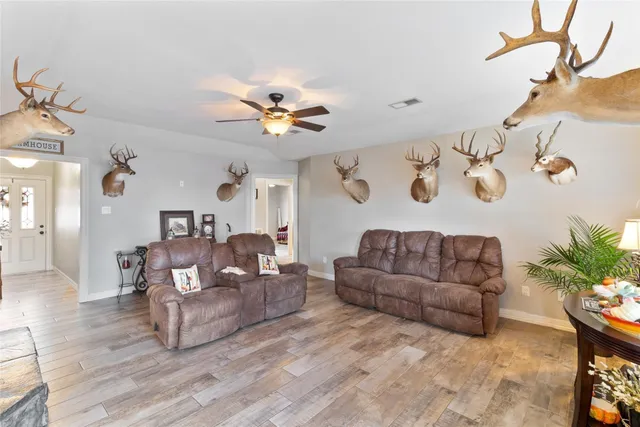 a living room with furniture and wooden floor