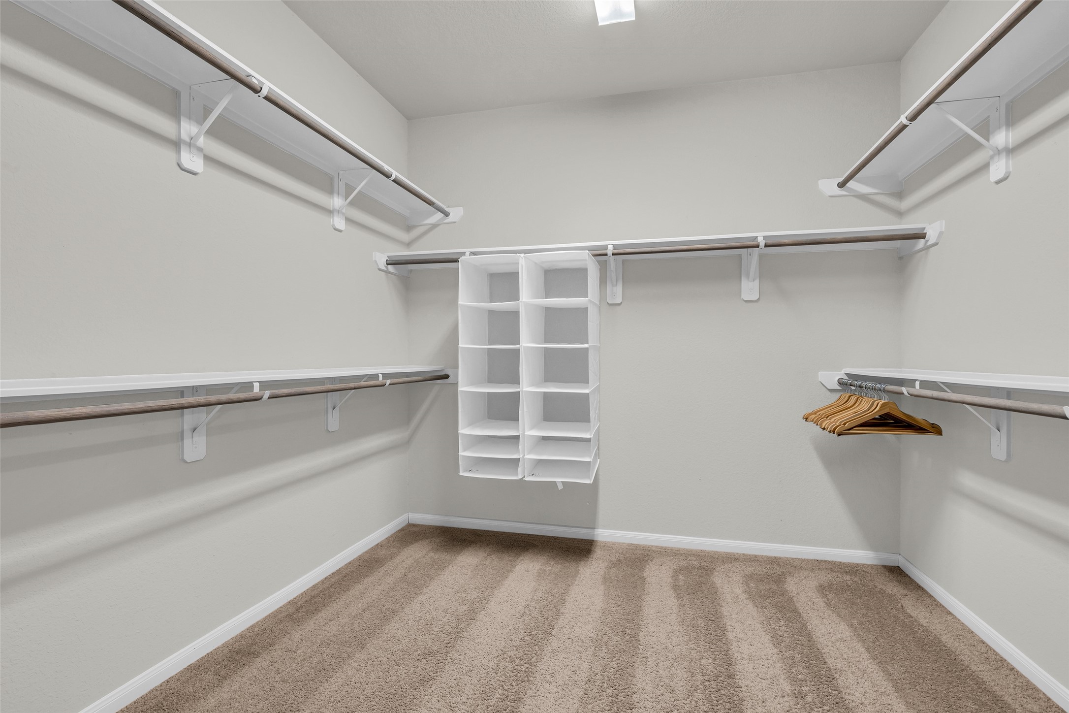 2344 Hagerman Road Conroe, TX 77384 - Photo 15 of 27 Generous walk-in closet with ample shelving and hanging space, perfect for organizing your wardrobe.