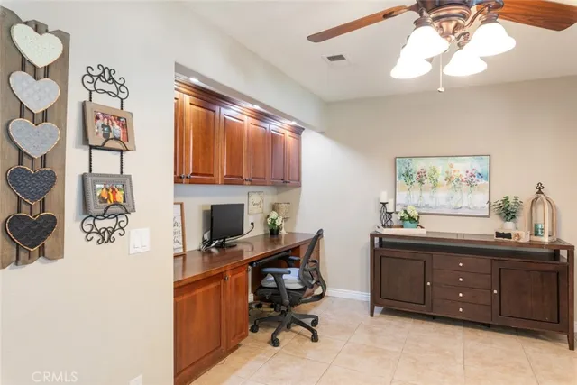 a view of a workspace with furniture and a window