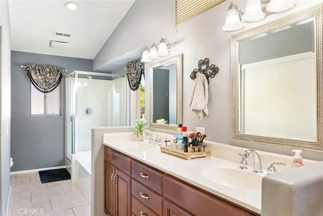 a bathroom with a double vanity sink and a mirror