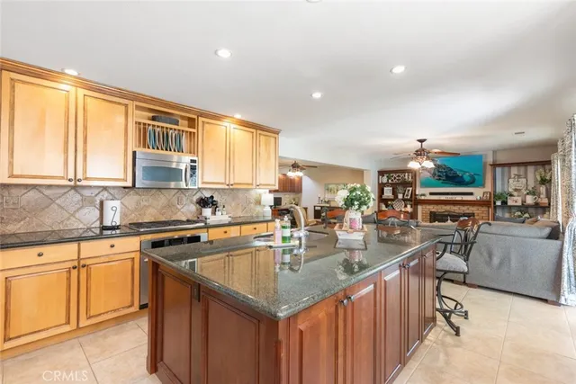 a kitchen with stainless steel appliances granite countertop a sink stove and cabinets